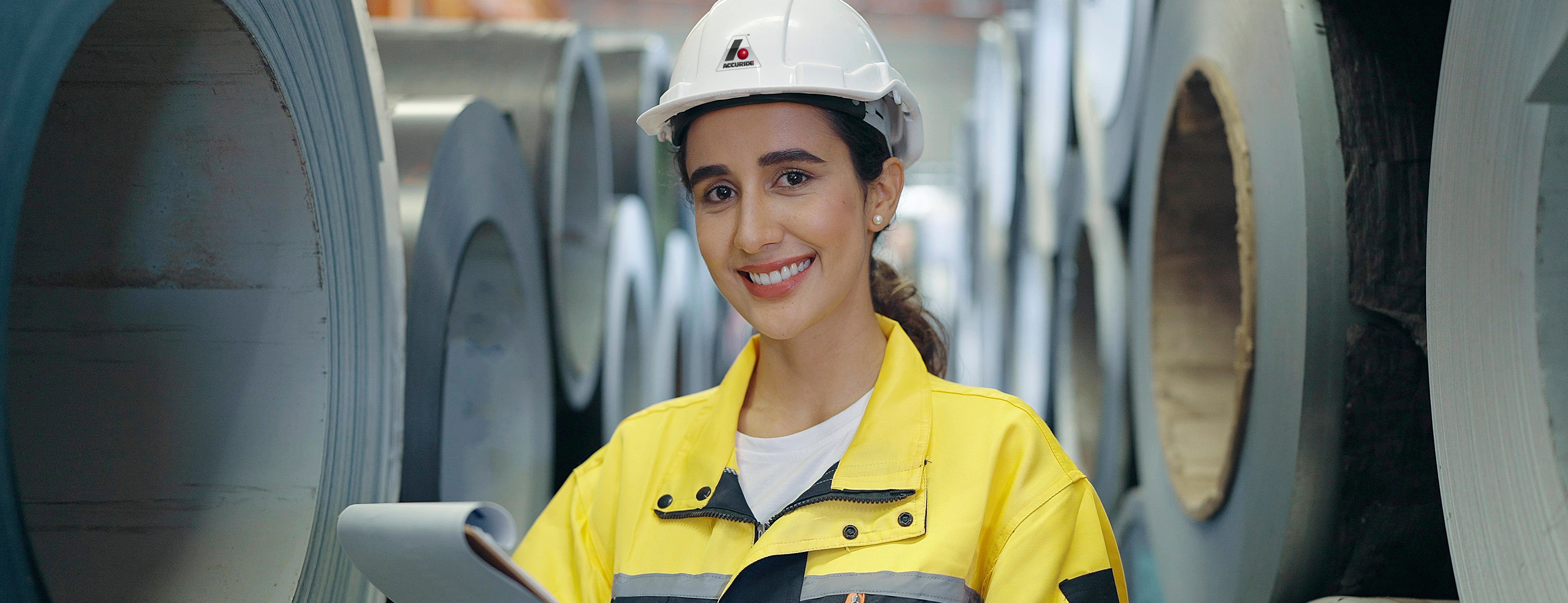 Worker Standing in front of steel coils